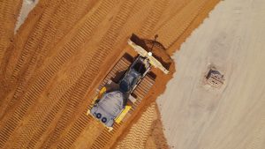 aerial footage of a tractor plowing dirt, industiral video production shoot