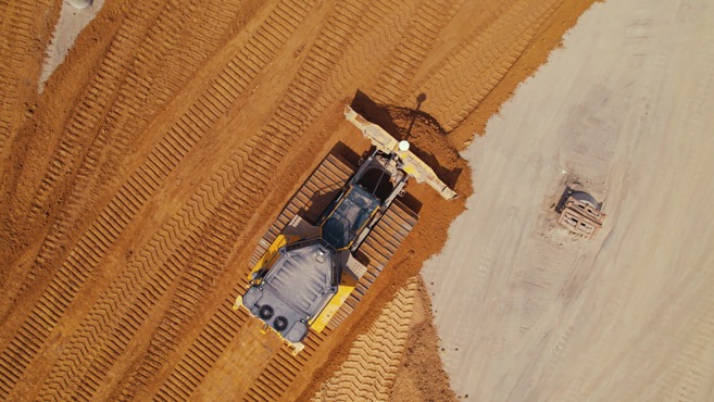 aerial footage of a tractor plowing dirt, industiral video production shoot